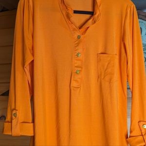 Woman's orange Ashley Blue shirt.